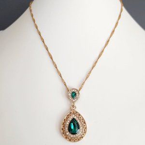 Ornate faux emerald and rhinestone gold pendant necklace